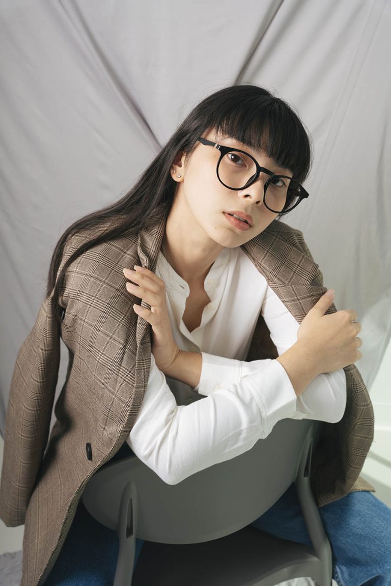 Beautiful asian thai long dark hair woman in white shirt wearing eyeglasses. Fashion portrait. Hipster.